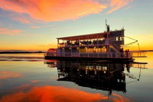Photo of the Dora Queen paddlewheel boat at sunset on Lake Dora.